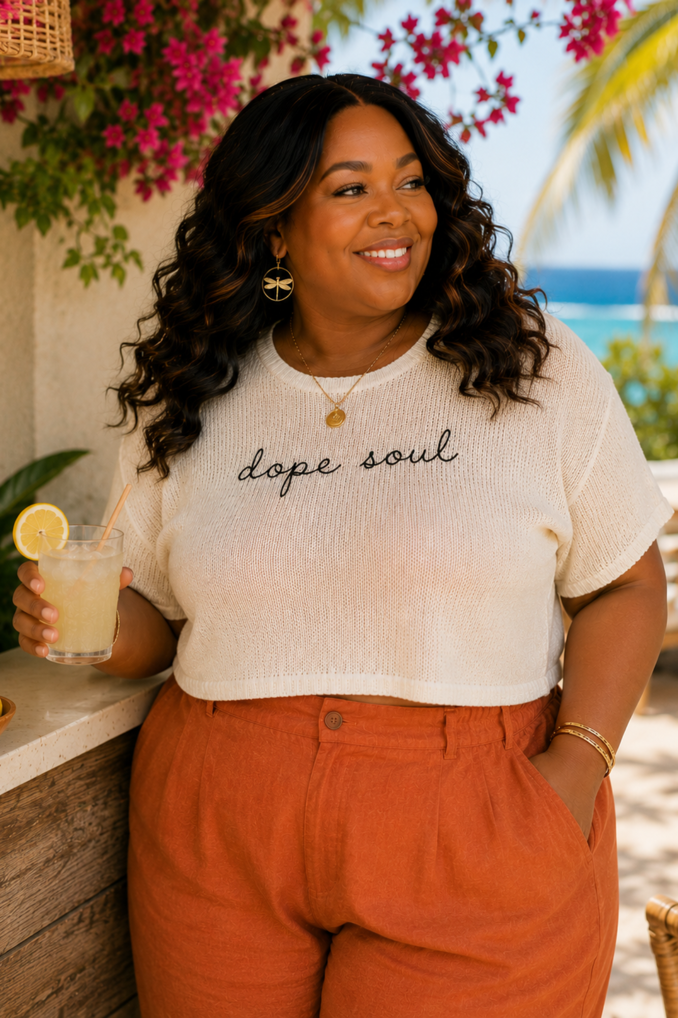 Woman wearing a 'dope soul' shirt by a tropical beach setting